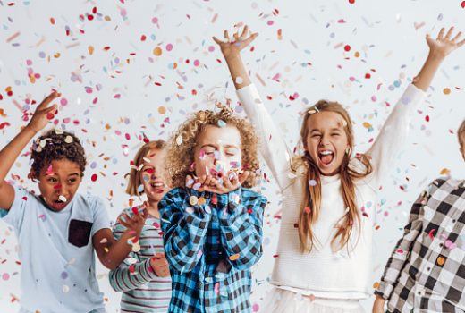 Happy kids having fun in a room full of confetti