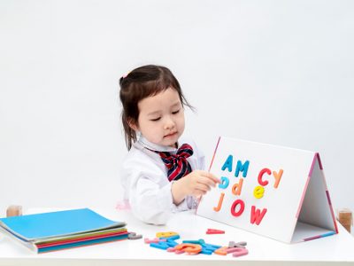 The lovely little girl is learning letters